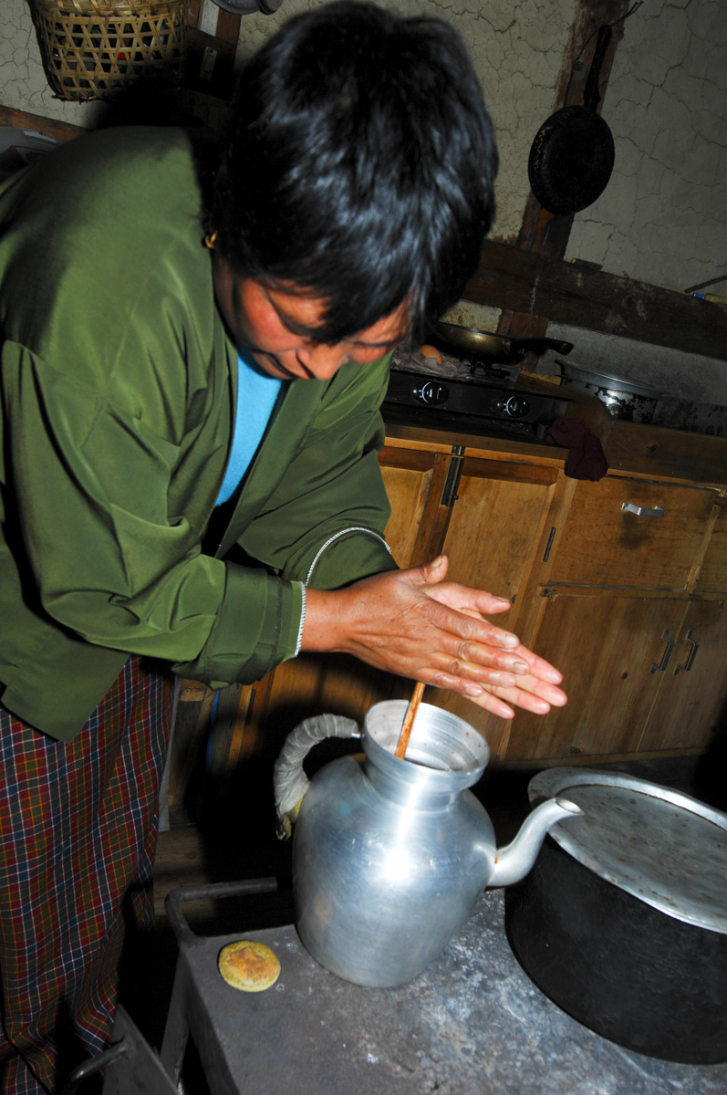 Being visiting with a farmer's family - Preparing traditional butter-tea